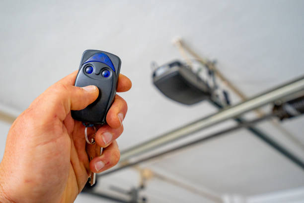 Garage door opening by itself due to garage door opener or remote interference | Summit Door LLC
